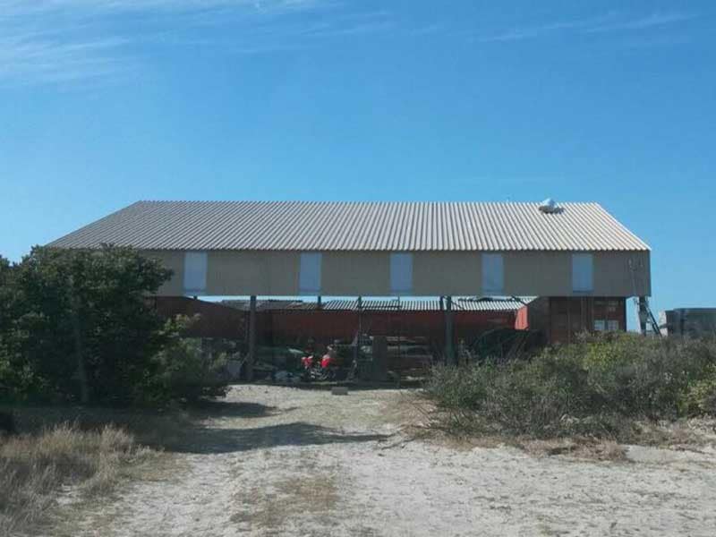 Steel structure erected over a row of shipping containers in the Western Cape