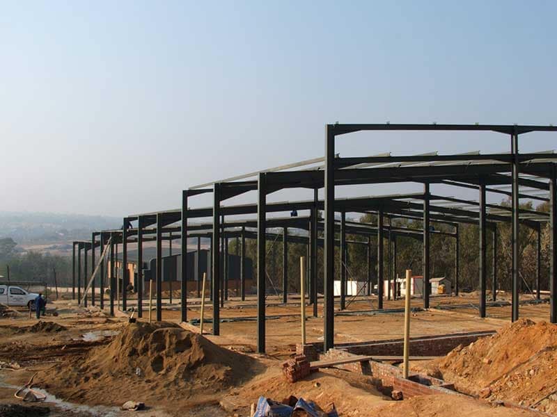Stepped steel mini factory units erected on a sloping site
