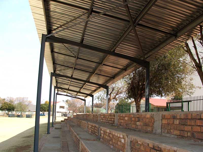 Steel shade structure covering a school swimming pool