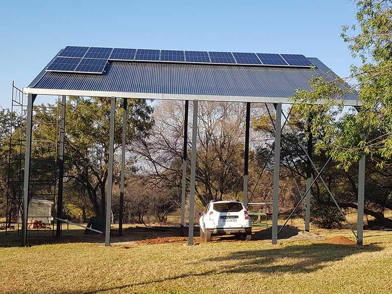 Multi-purpose 7 by 12 metre steel structure with solar panels, carport and two-bedroom dwelling above