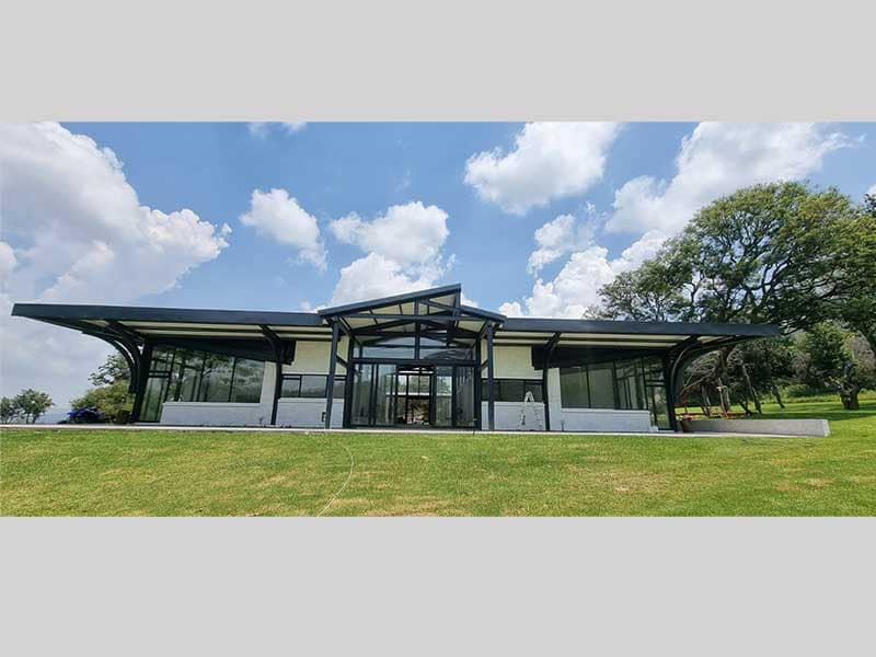 Customised steel-frame house with two bedroom wings and a central living area